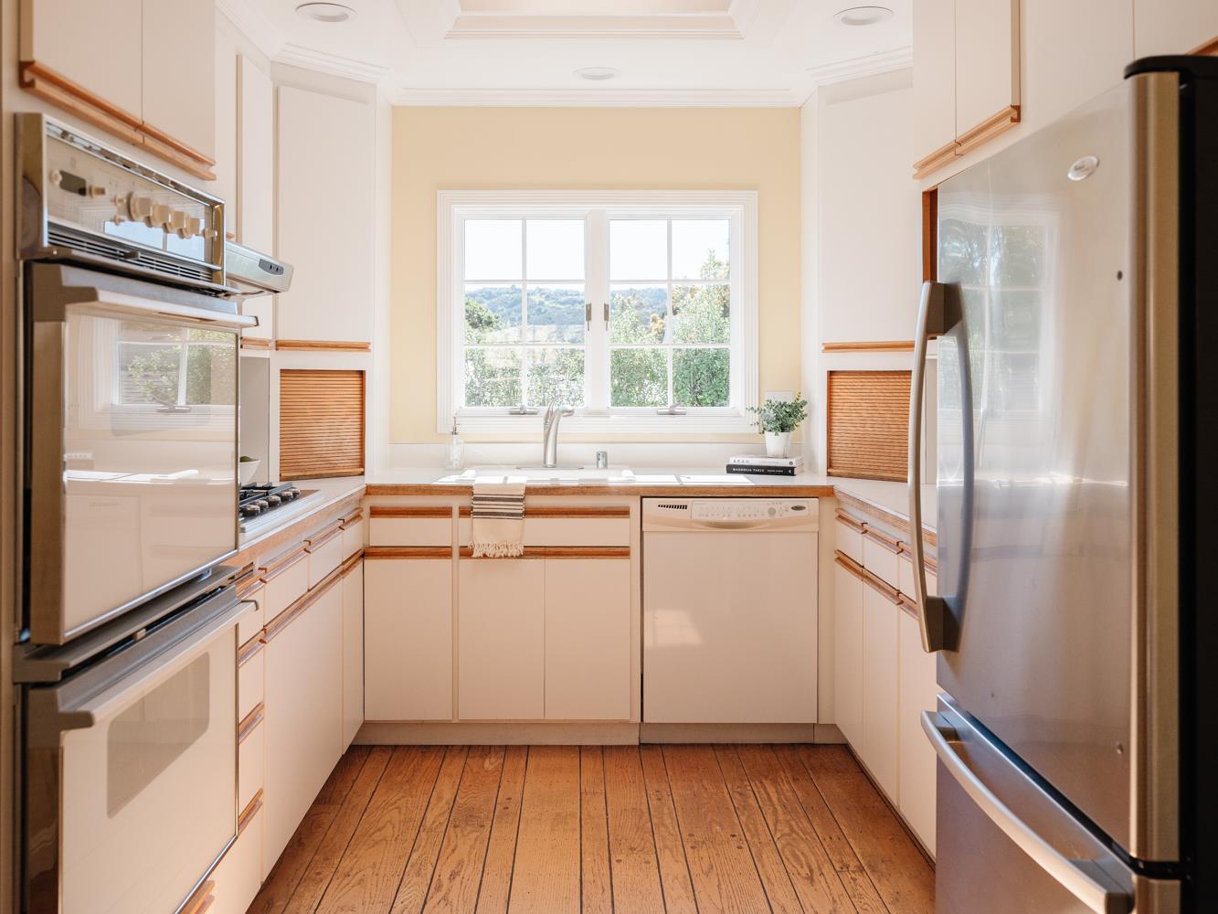 802 Covington Road Belmont, CA 94002 - Photo 8 of 28 a kitchen with a refrigerator sink and cabinets