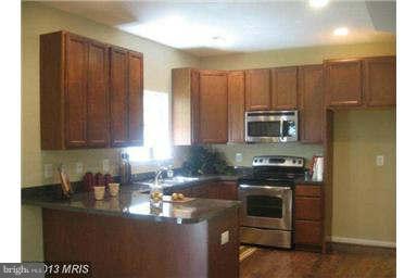 5518 Deale Churchton Road Churchton, MD 20733 - Photo 2 of 11 a kitchen with stainless steel appliances granite countertop a stove a sink and a microwave