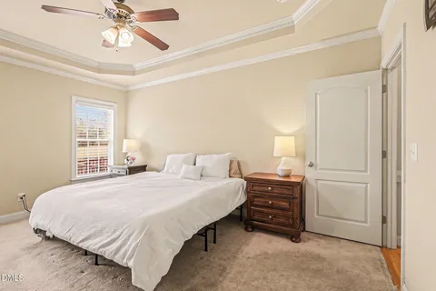 a bedroom with a bed and a chandelier