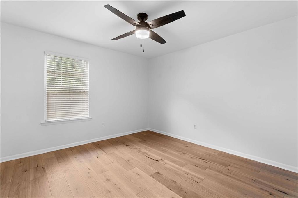1150 Collier Road Northwest, Unit A1 Atlanta, GA 30318 - Photo 16 of 27 an empty room with wooden floor and windows