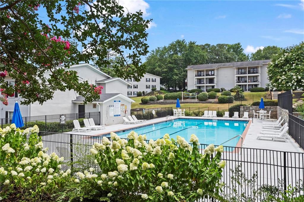 1150 Collier Road Northwest, Unit A1 Atlanta, GA 30318 - Photo 20 of 27 a view of a house with backyard outdoor seating area and furniture