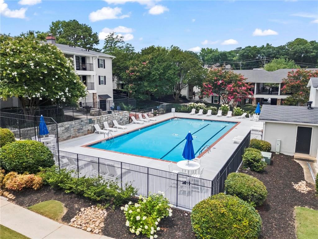 1150 Collier Road Northwest, Unit A1 Atlanta, GA 30318 - Photo 21 of 27 a view of a swimming pool with a lounge chairs