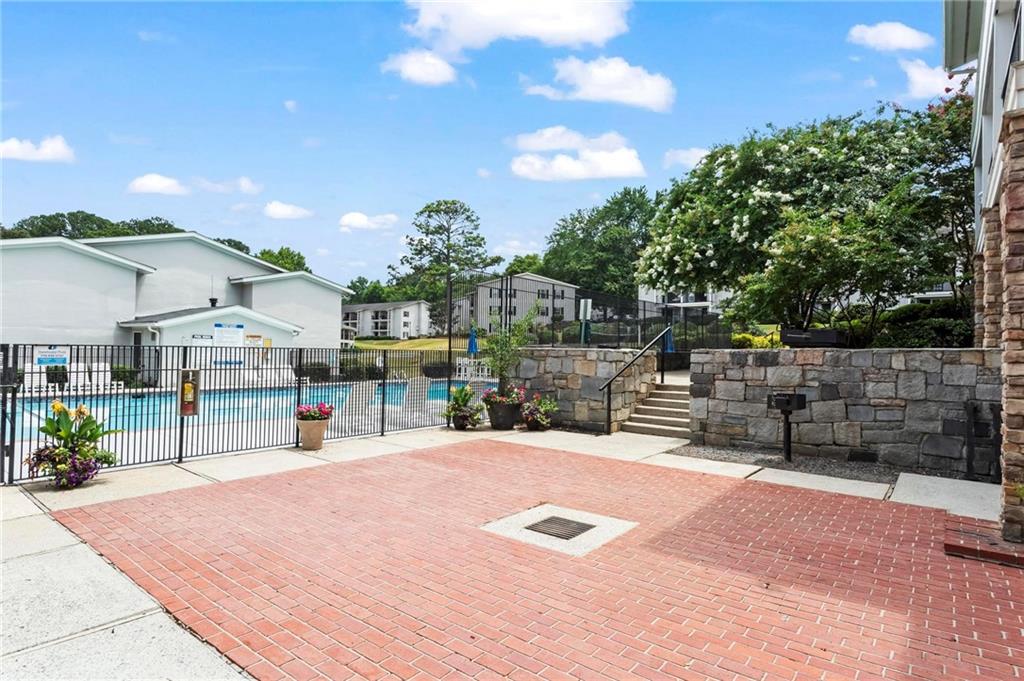1150 Collier Road Northwest, Unit A1 Atlanta, GA 30318 - Photo 22 of 27 a swimming pool with outdoor seating and yard
