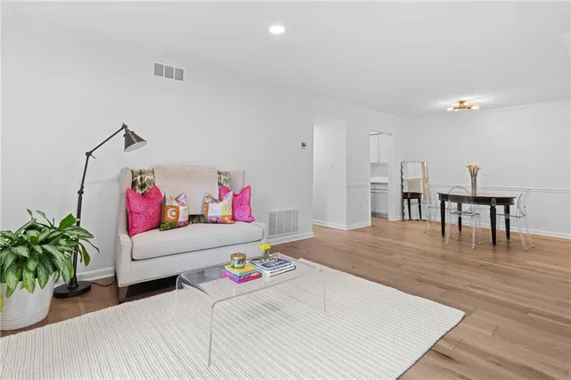 a living room with furniture and a wooden floor