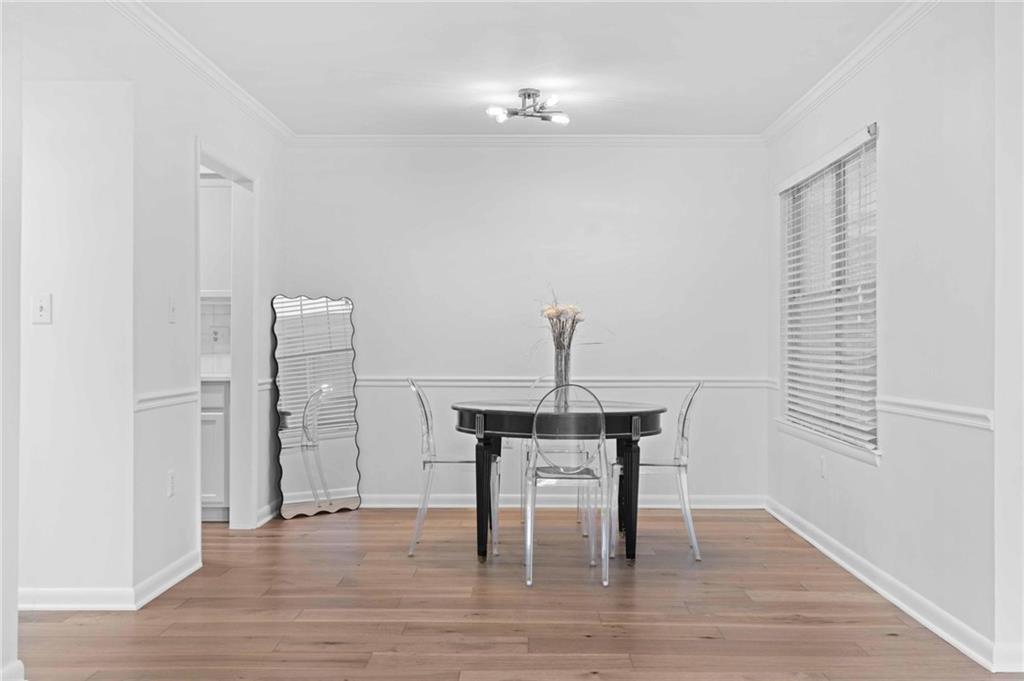 1150 Collier Road Northwest, Unit A1 Atlanta, GA 30318 - Photo 6 of 27 a view of a room with wooden floor table and chairs