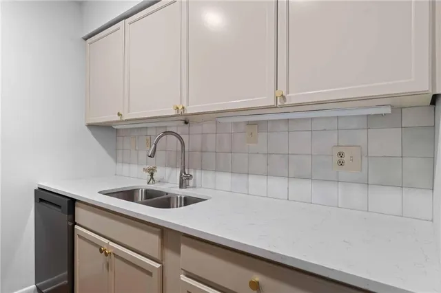 a kitchen with a sink and cabinets