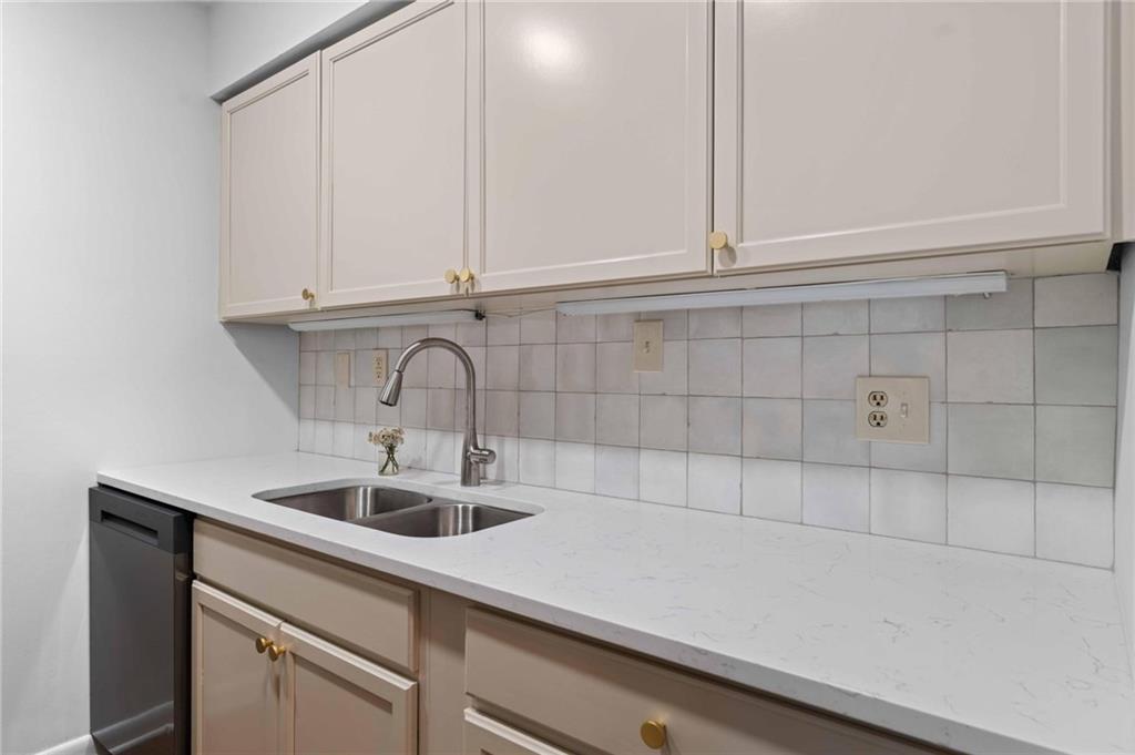 1150 Collier Road Northwest, Unit A1 Atlanta, GA 30318 - Photo 7 of 27 a kitchen with a sink and cabinets