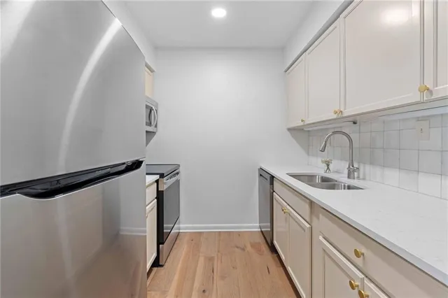 a bathroom with a sink a mirror and shower