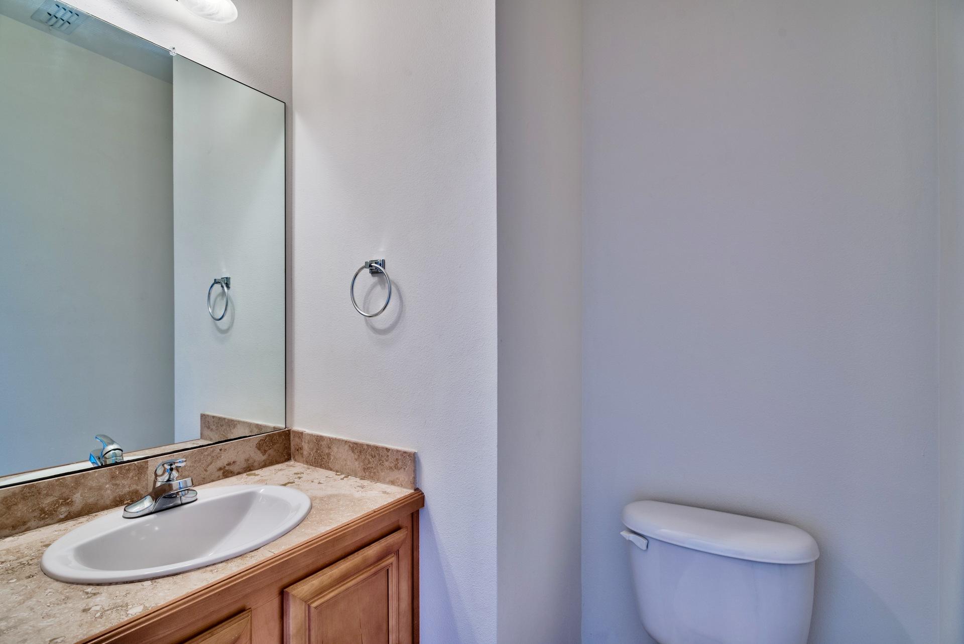 15284 331 Business, Unit 5A Freeport, FL 32439 - Photo 13 of 31 a bathroom with a granite countertop sink a toilet and a mirror