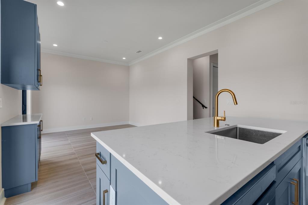 772 Gran Kaymen Way Apollo Beach, FL 33572 - Photo 11 of 35 a kitchen with a sink and a refrigerator