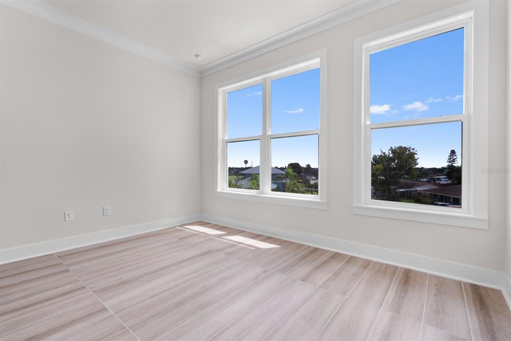 772 Gran Kaymen Way Apollo Beach, FL 33572 - Photo 16 of 35 a view of an empty room with wooden floor and a window