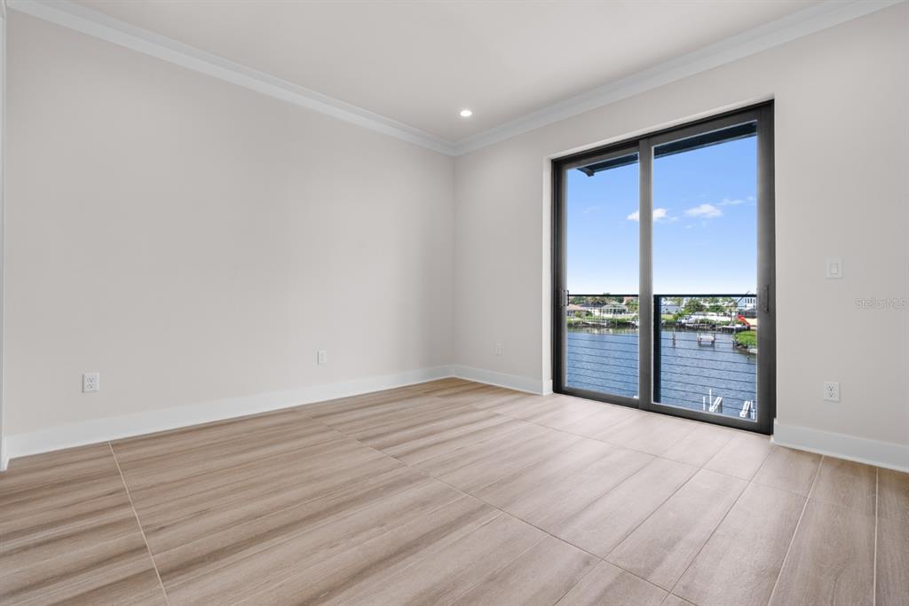 772 Gran Kaymen Way Apollo Beach, FL 33572 - Photo 21 of 35 wooden floor in an empty room with a window