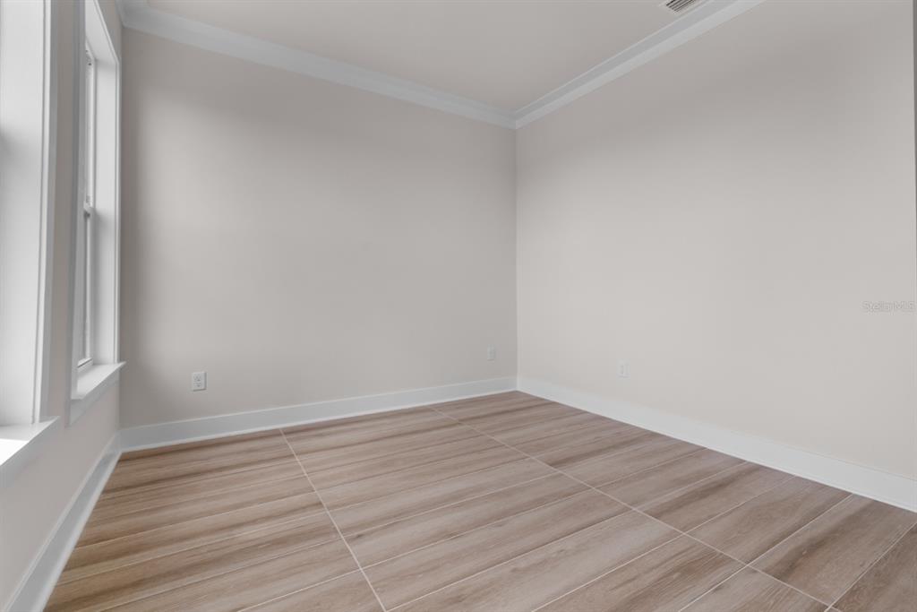 772 Gran Kaymen Way Apollo Beach, FL 33572 - Photo 23 of 35 a view of an empty room with wooden floor