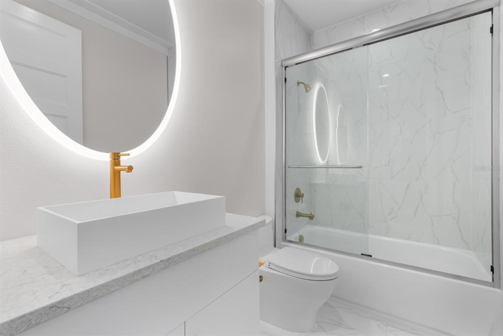 772 Gran Kaymen Way Apollo Beach, FL 33572 - Photo 24 of 35 a bathroom with a toilet a sink and shower