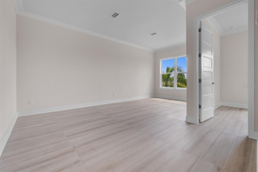 772 Gran Kaymen Way Apollo Beach, FL 33572 - Photo 30 of 35 a view of an empty room with wooden floor and window