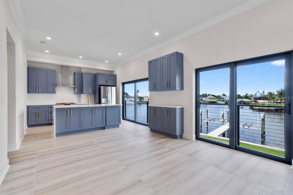 772 Gran Kaymen Way Apollo Beach, FL 33572 - Photo 7 of 35 a large kitchen with stainless steel appliances granite countertop a large counter top and a wooden floors