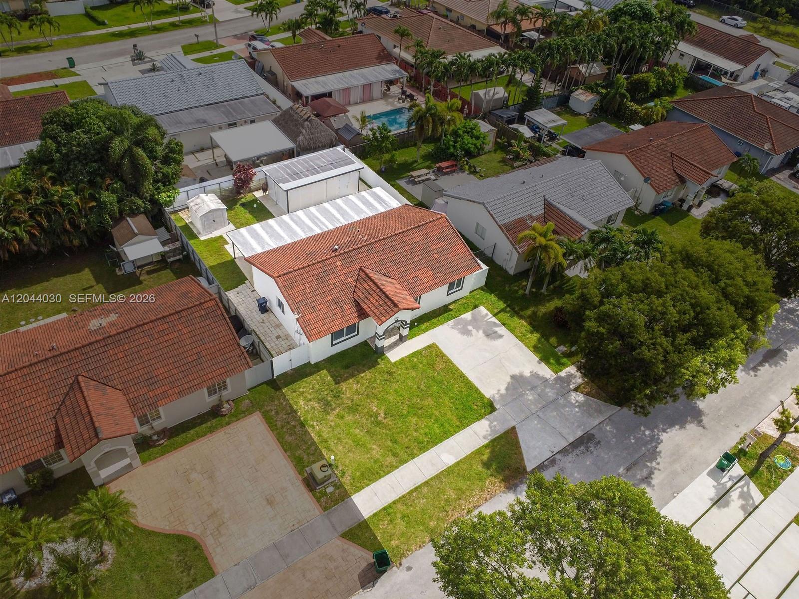12551 Southwest 223rd Street Miami, FL 33170 - Photo 32 of 35 an aerial view of a house with a garden and lake view