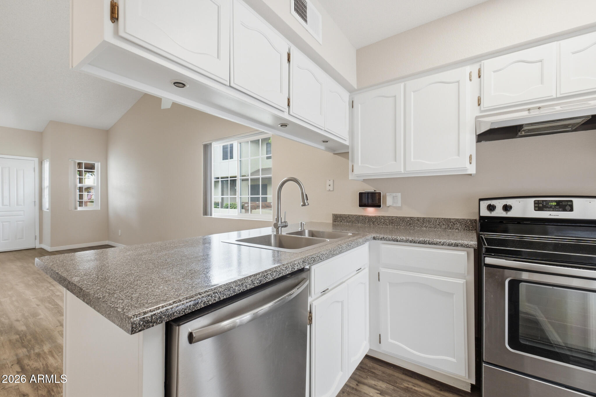 170 East Guadalupe Road, Unit 112 Gilbert, AZ 85234 - Photo 15 of 22 a kitchen with granite countertop a sink stainless steel appliances and cabinets