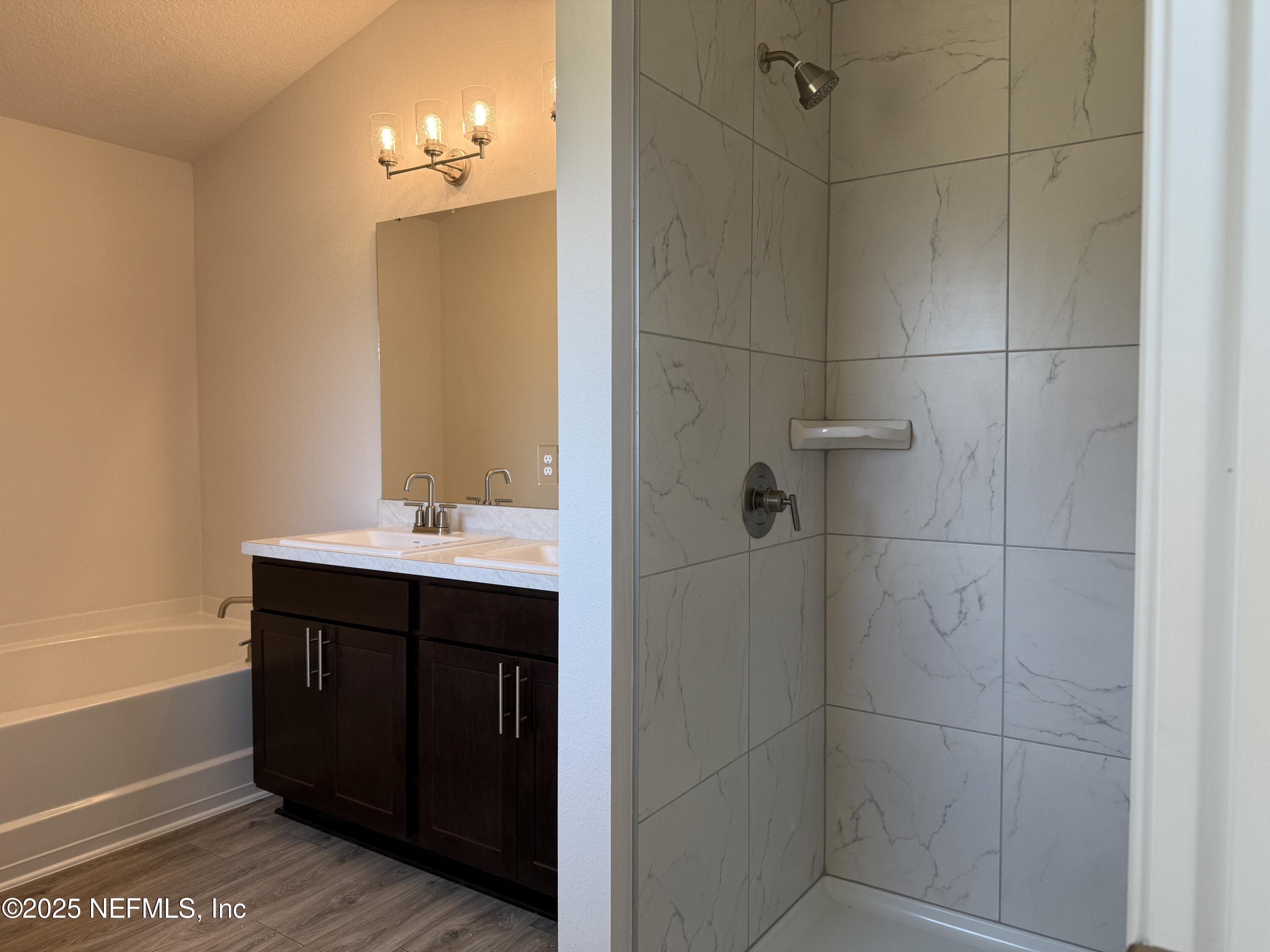 8278 Helmsley Boulevard Jacksonville, FL 32219 - Photo 15 of 27 a bathroom with a sink and mirror