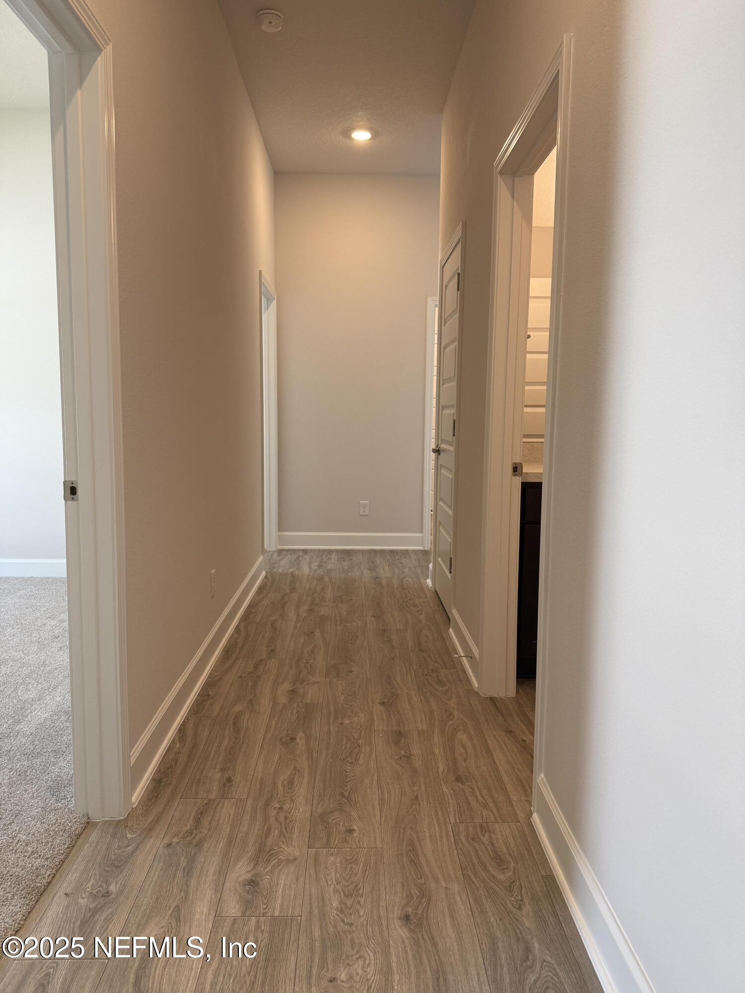 8278 Helmsley Boulevard Jacksonville, FL 32219 - Photo 18 of 27 a view of hallway with wooden floor