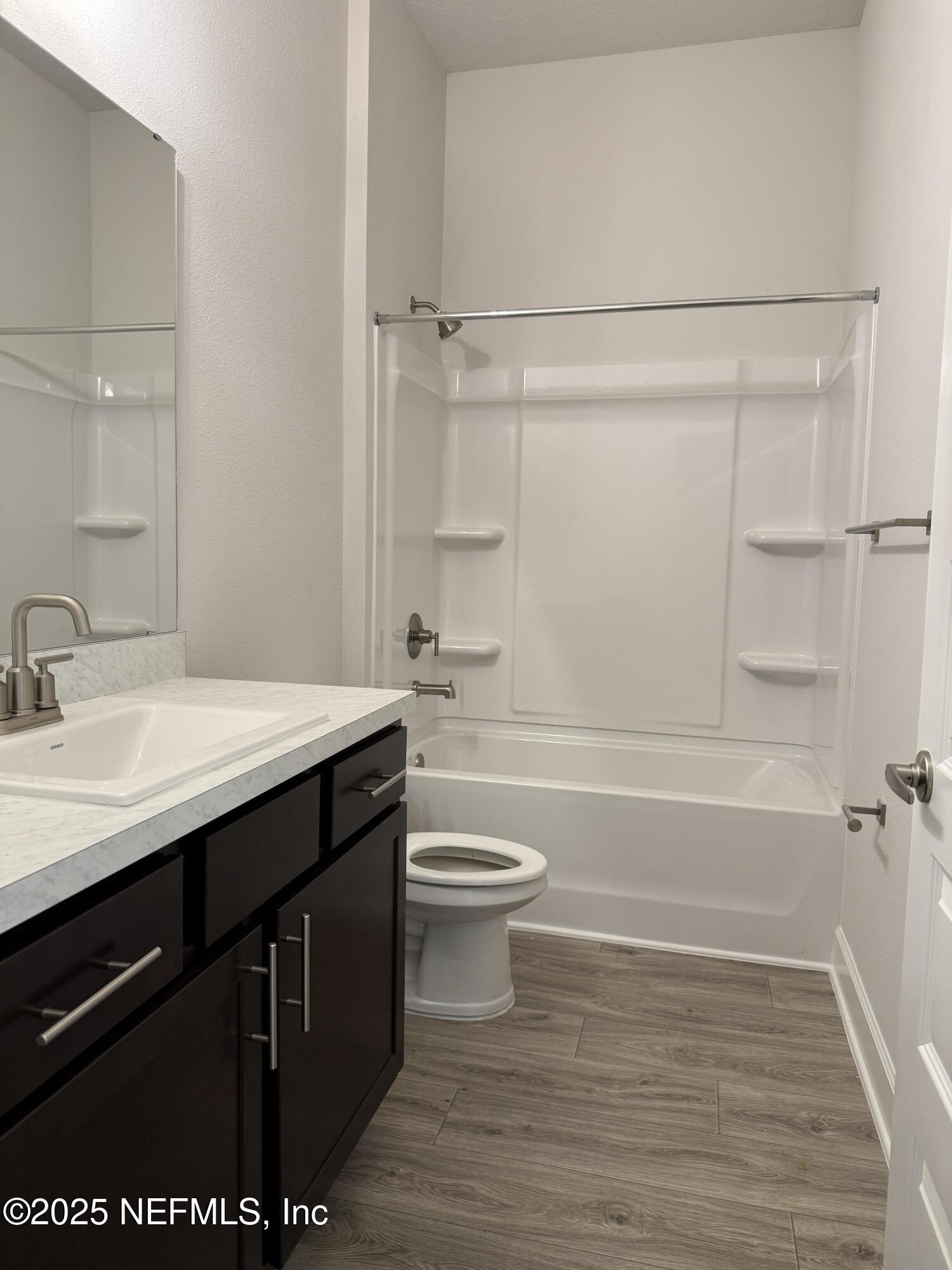 8278 Helmsley Boulevard Jacksonville, FL 32219 - Photo 20 of 27 a bathroom with a sink a toilet a mirror and shower