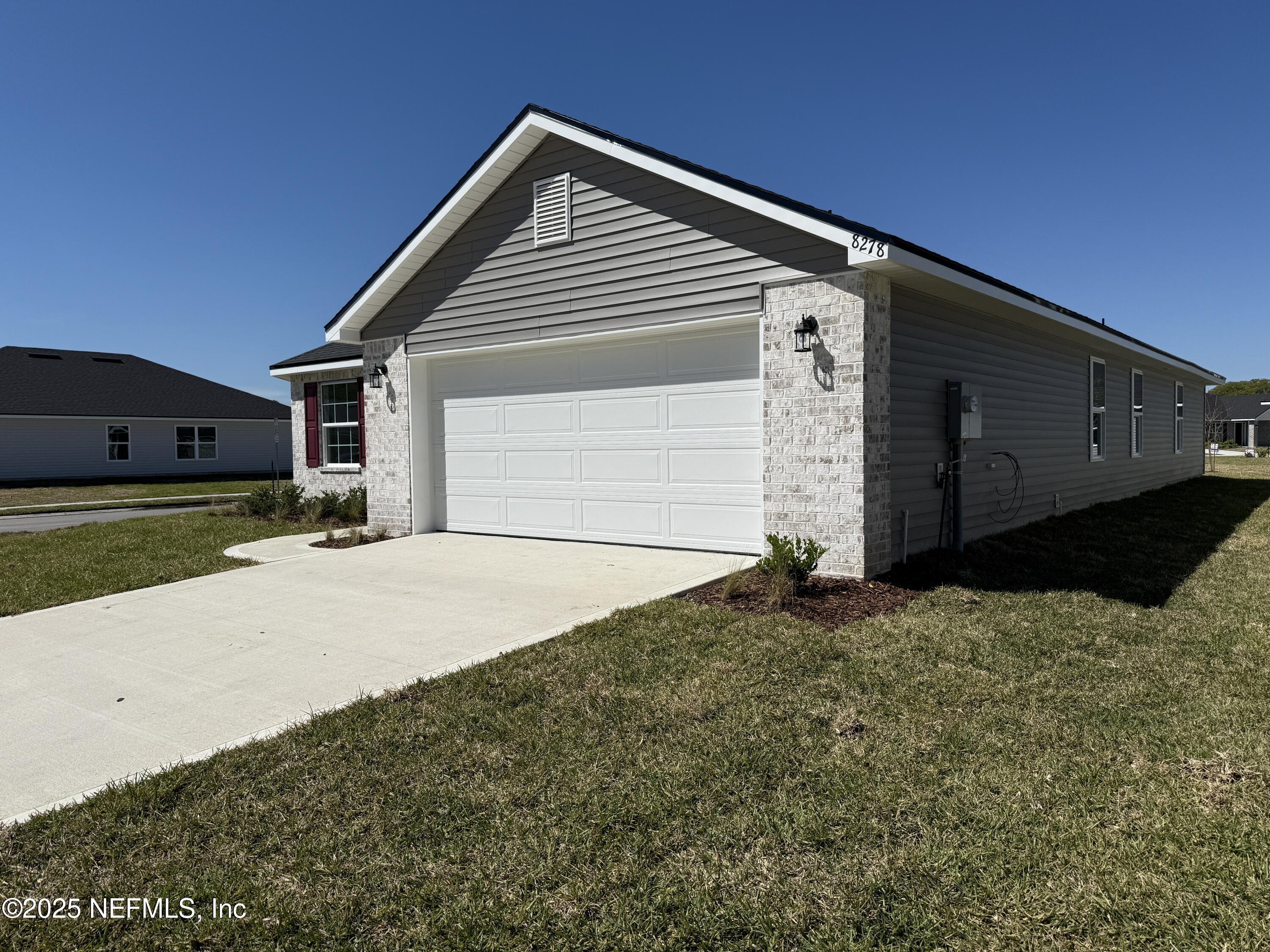 8278 Helmsley Boulevard Jacksonville, FL 32219 - Photo 3 of 27 a front view of a house with a yard