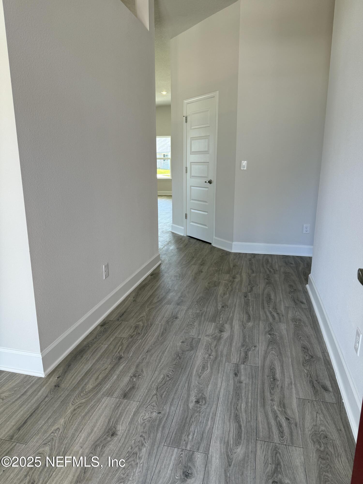 8278 Helmsley Boulevard Jacksonville, FL 32219 - Photo 4 of 27 an empty room with wooden floor and closet
