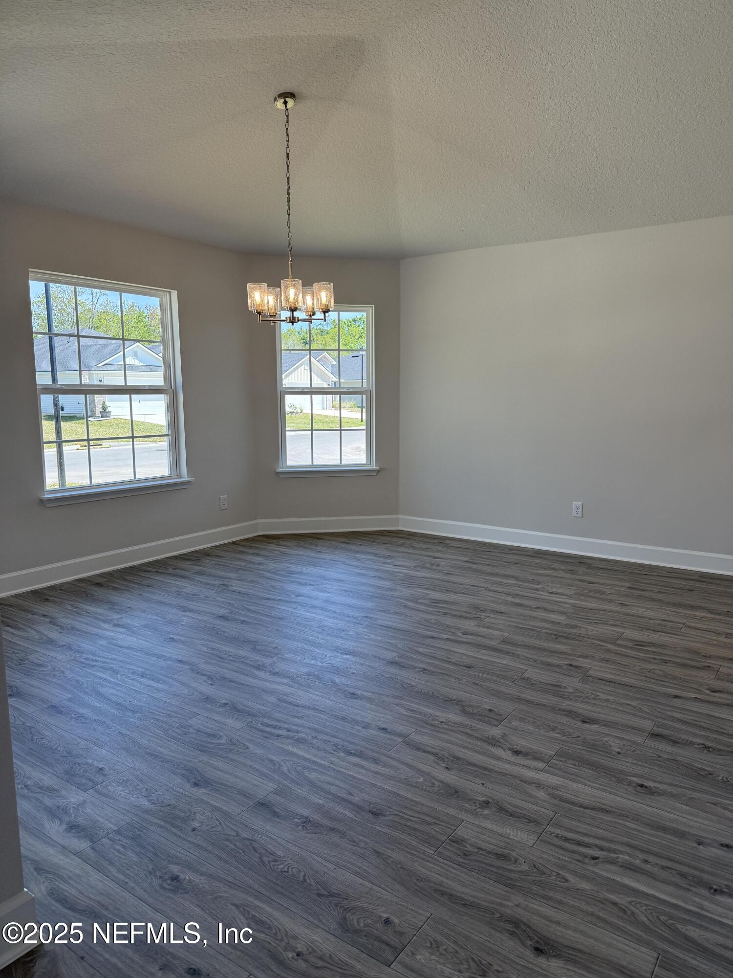 8278 Helmsley Boulevard Jacksonville, FL 32219 - Photo 5 of 27 an empty room with wooden floor and windows