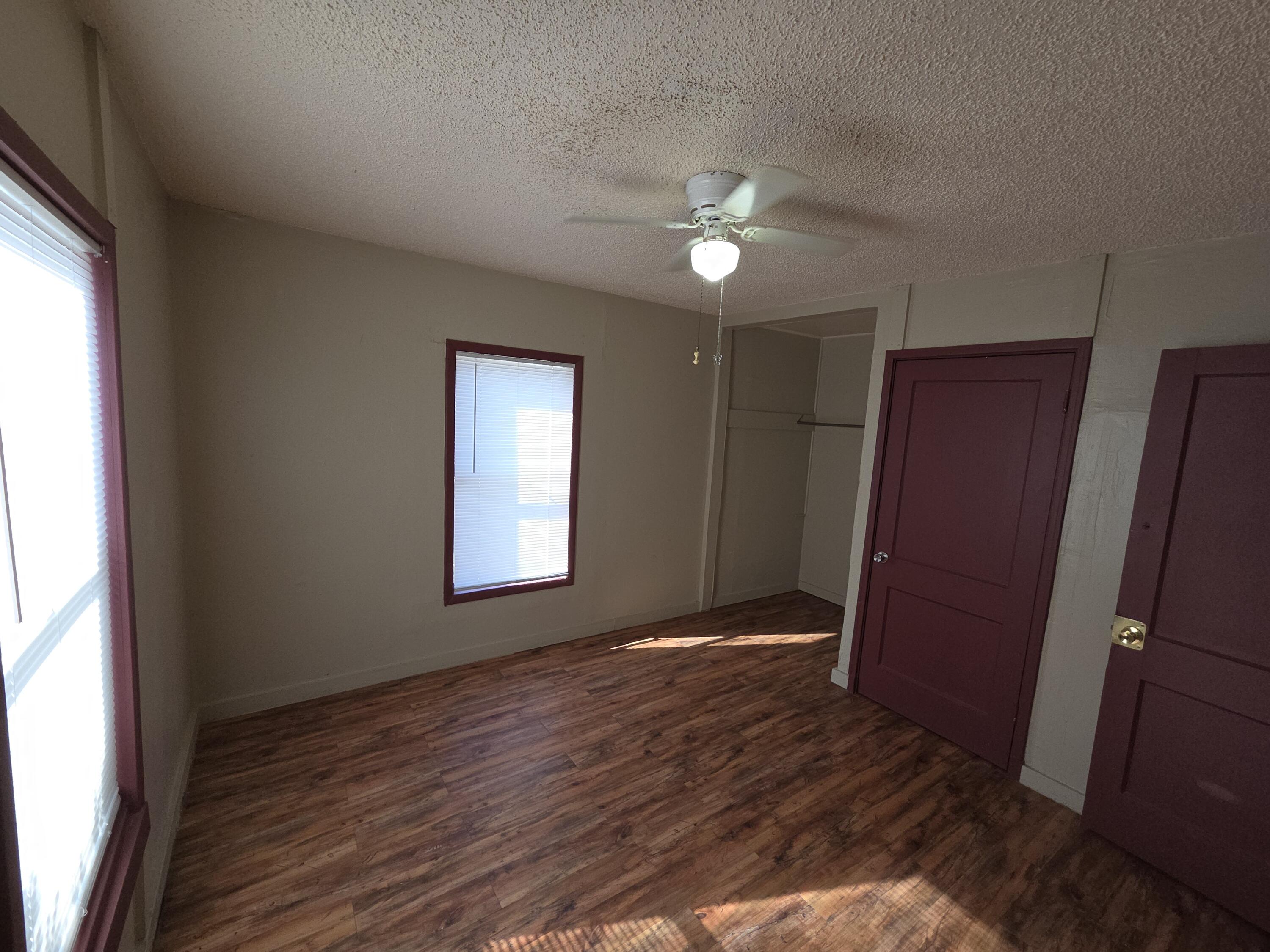 600 Vernon Plainview, TX 79072 - Photo 11 of 30 a view of an empty room with wooden floor and a window