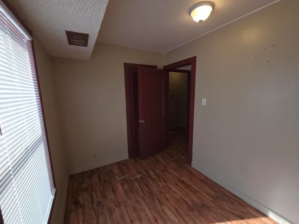 a view of hallway with wooden floor