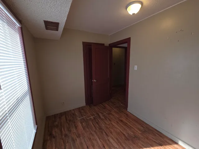 a view of hallway with wooden floor