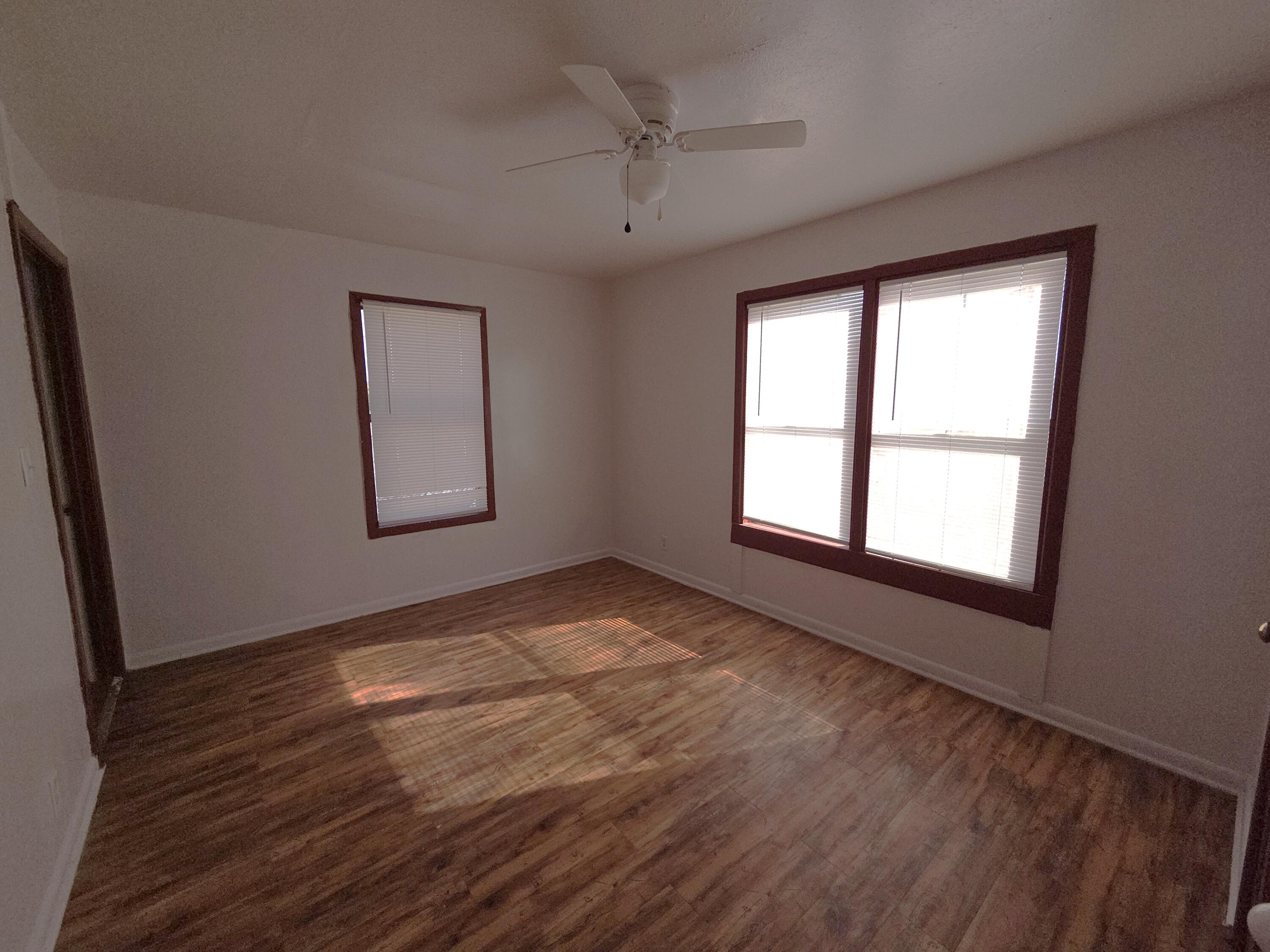 600 Vernon Plainview, TX 79072 - Photo 16 of 30 a view of an empty room with a window and wooden floor