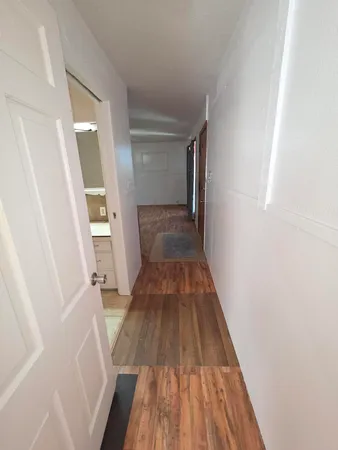 a view of a hallway view with wooden floor and staircase