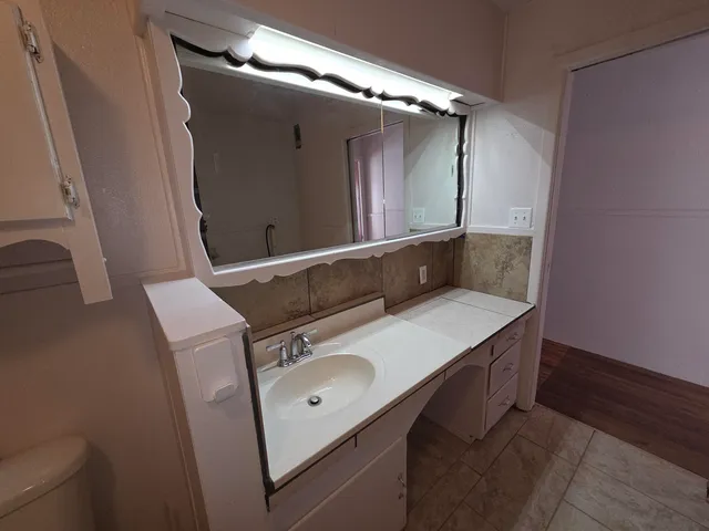 a bathroom with a sink and mirror