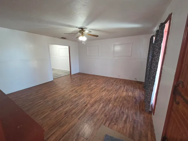 wooden floor in an empty room with a window