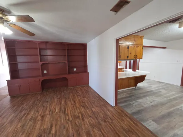 a view of an empty room and wooden floor