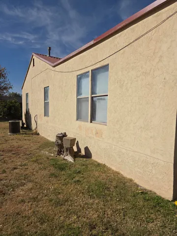 a backyard of a house with table and chairs