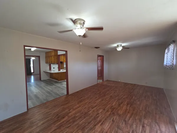a view of empty room with wooden floor