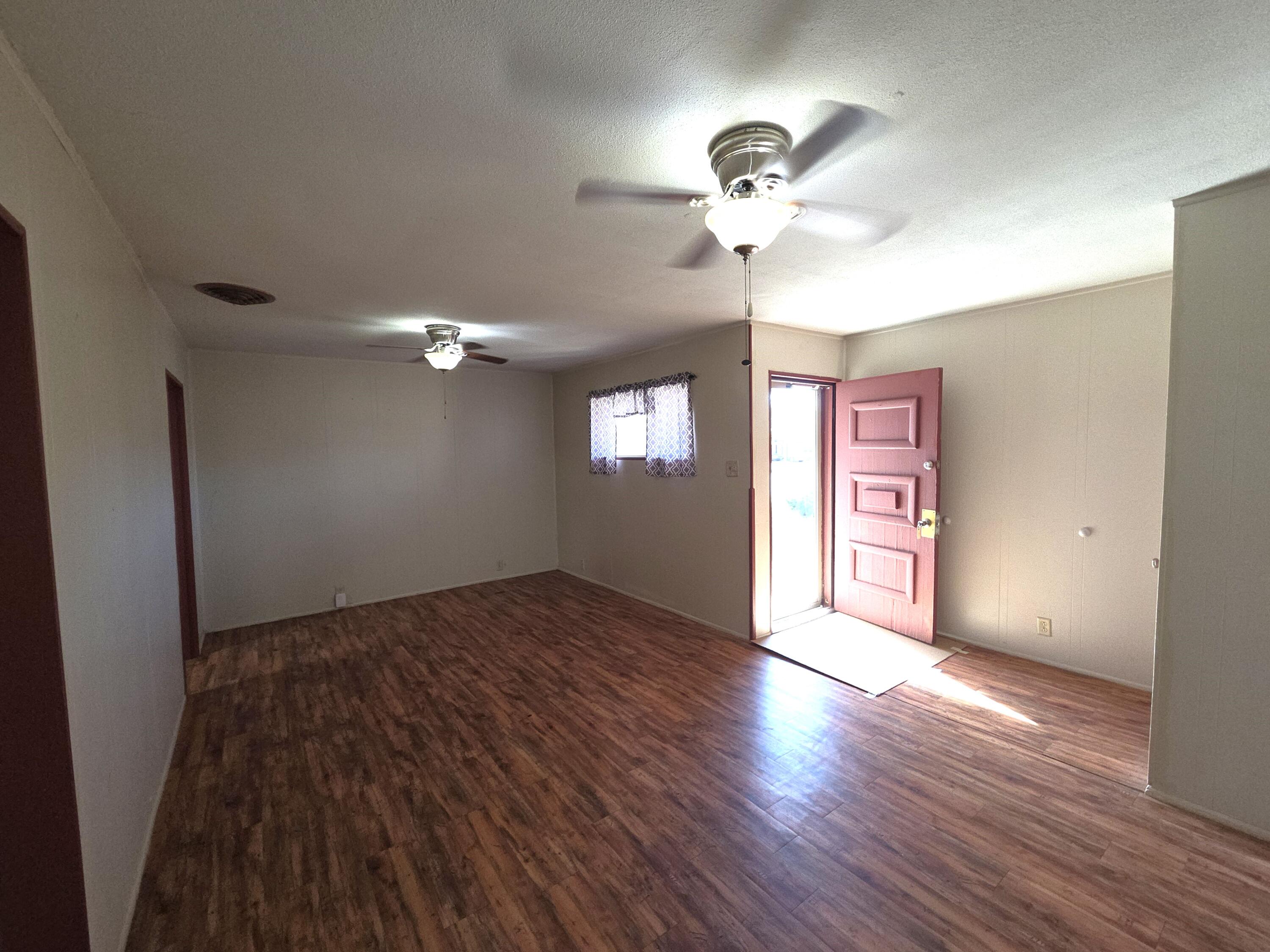 600 Vernon Plainview, TX 79072 - Photo 4 of 30 a view of an empty room with wooden floor and a window