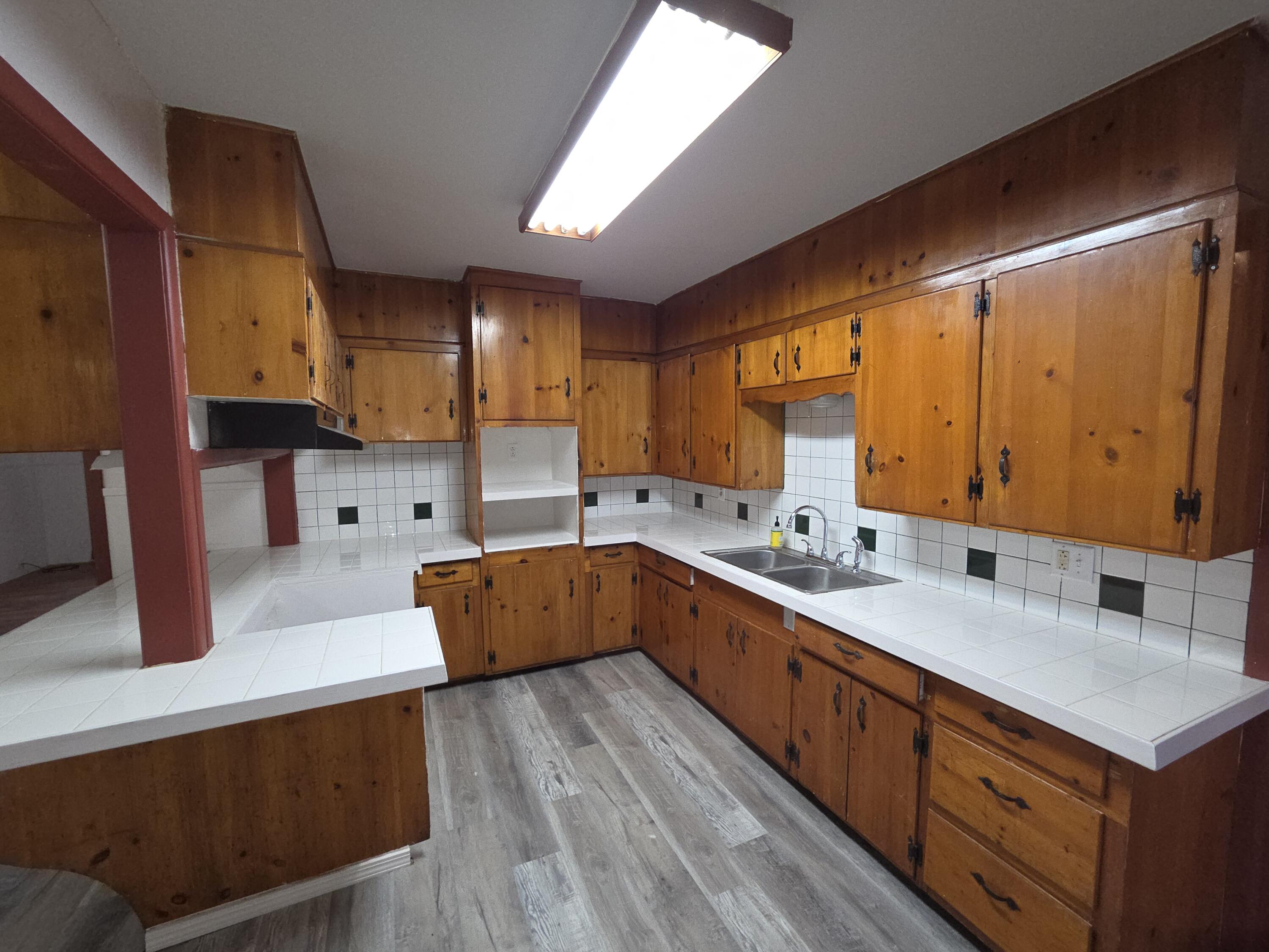 600 Vernon Plainview, TX 79072 - Photo 6 of 30 a kitchen with stainless steel appliances sink cabinets and wooden floor