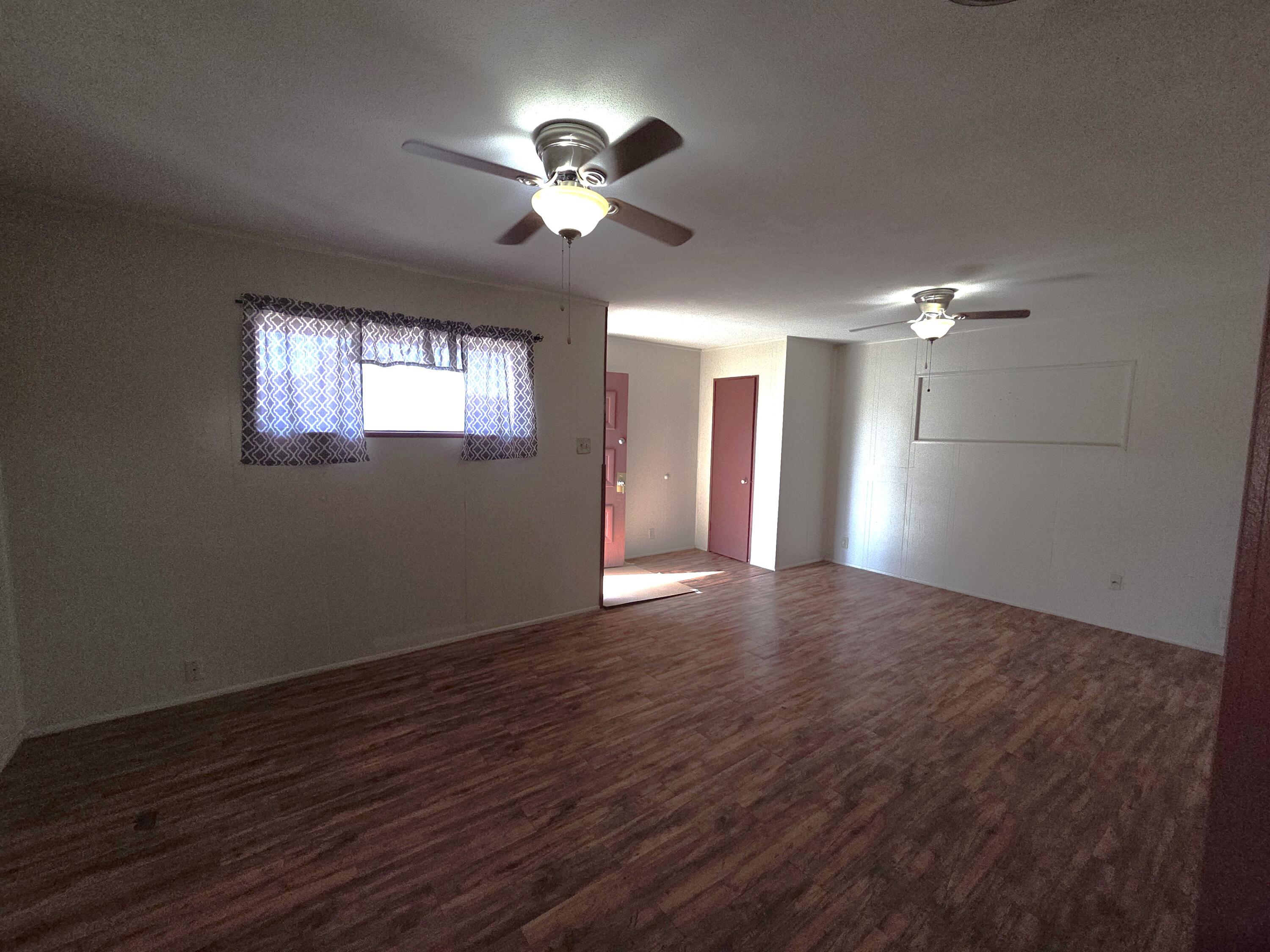 600 Vernon Plainview, TX 79072 - Photo 8 of 30 a view of an empty room with wooden floor and chandelier fan