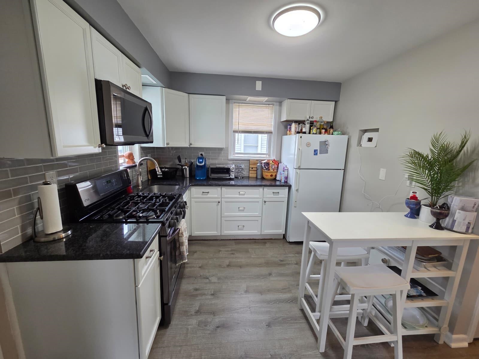 166 Carmita Avenue, Unit 2 Rutherford, NJ 07070 - Photo 1 of 27 a kitchen with granite countertop a sink stove and refrigerator