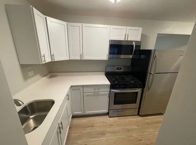 a kitchen with a sink and a refrigerator