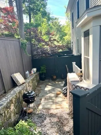 a view of a backyard with chair and table