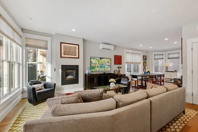 a living room with furniture kitchen view and a fireplace