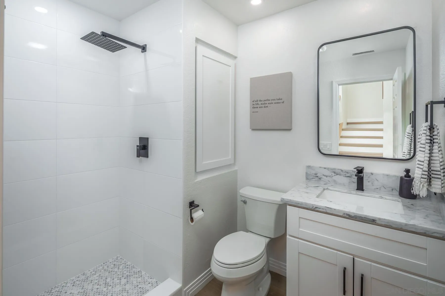 588 Melba Road Encinitas, CA 92024 - Photo 12 of 23 a bathroom with a granite countertop sink a toilet and mirror