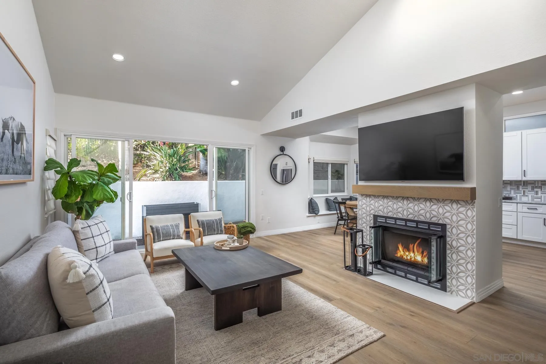 588 Melba Road Encinitas, CA 92024 - Photo 4 of 23 a living room with furniture a flat screen tv and a fireplace