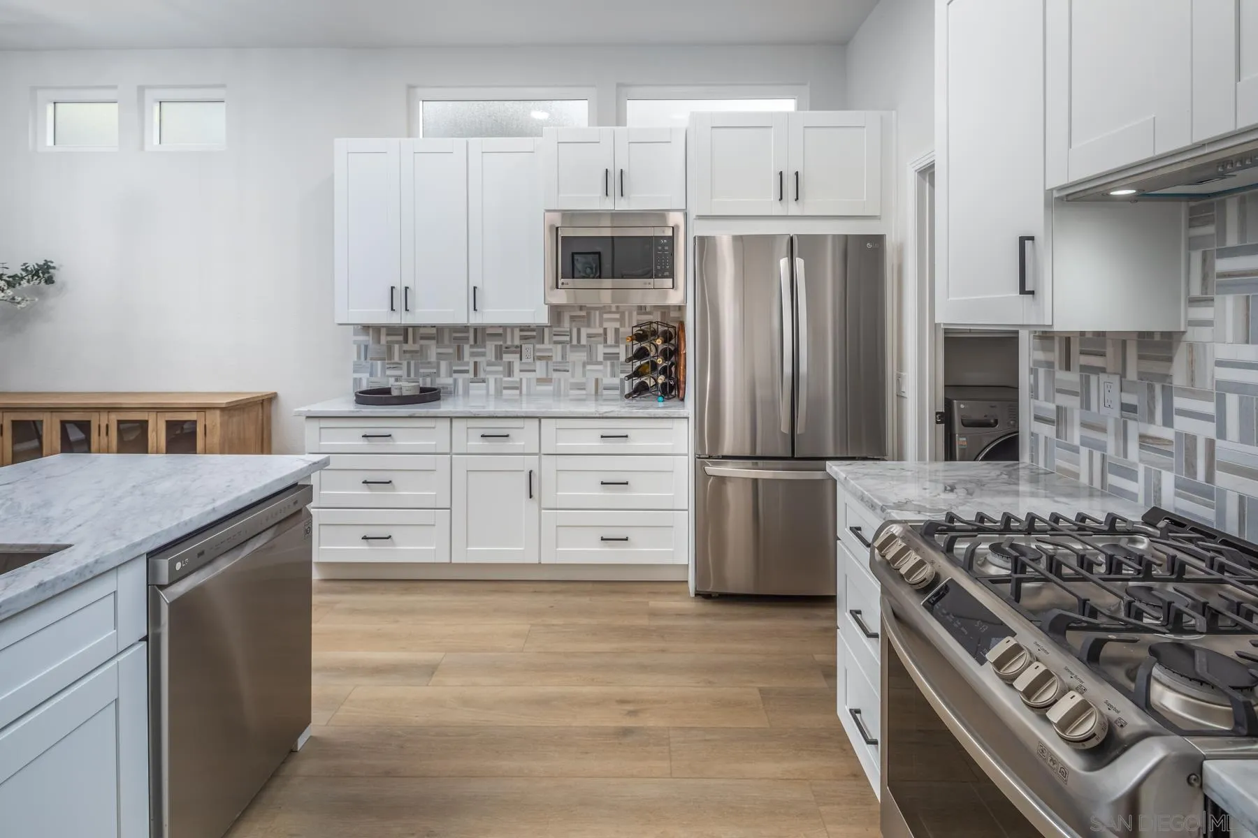 588 Melba Road Encinitas, CA 92024 - Photo 7 of 23 a kitchen with stainless steel appliances granite countertop a stove and a refrigerator
