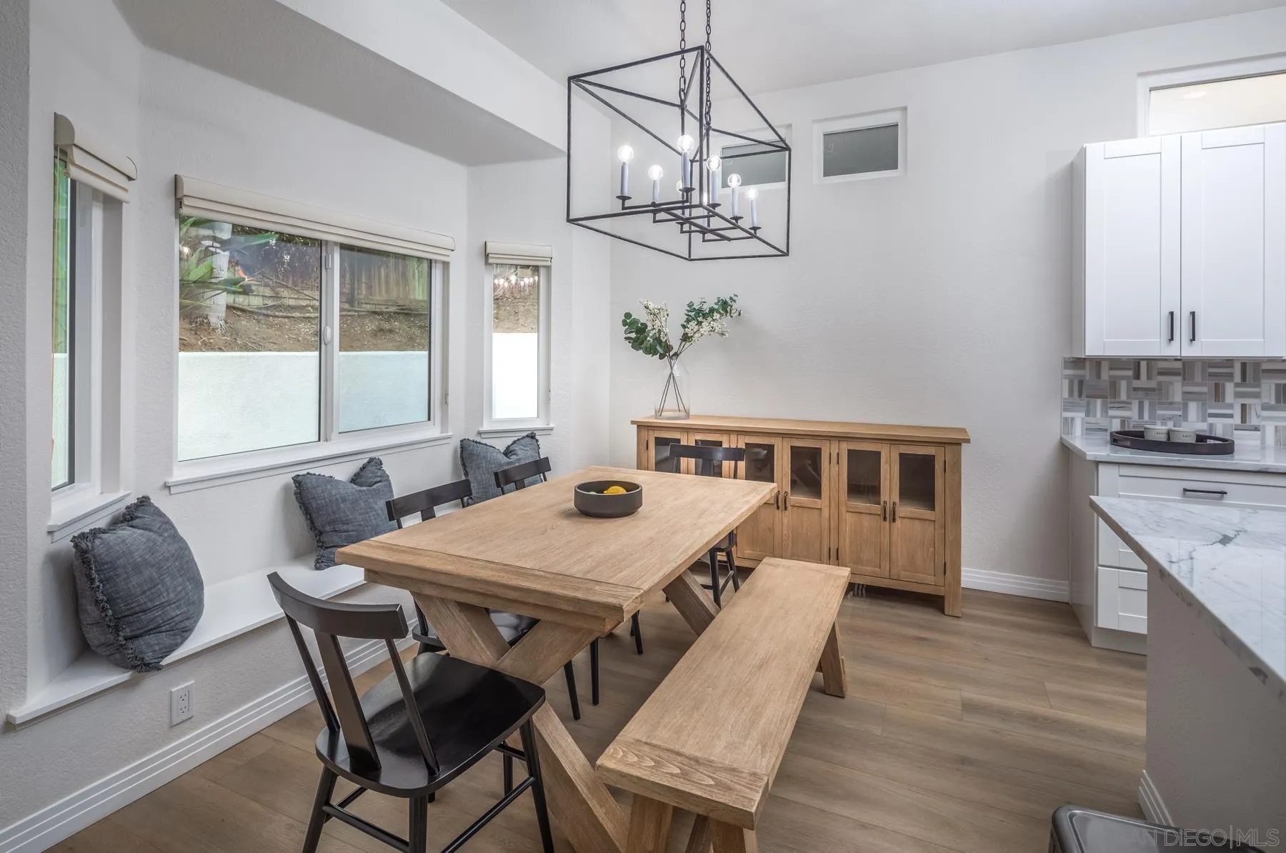 588 Melba Road Encinitas, CA 92024 - Photo 9 of 23 a view of a dining room with furniture a chandelier and wooden floor