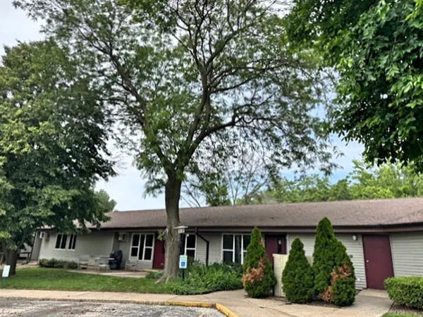 a front view of a house with a garden